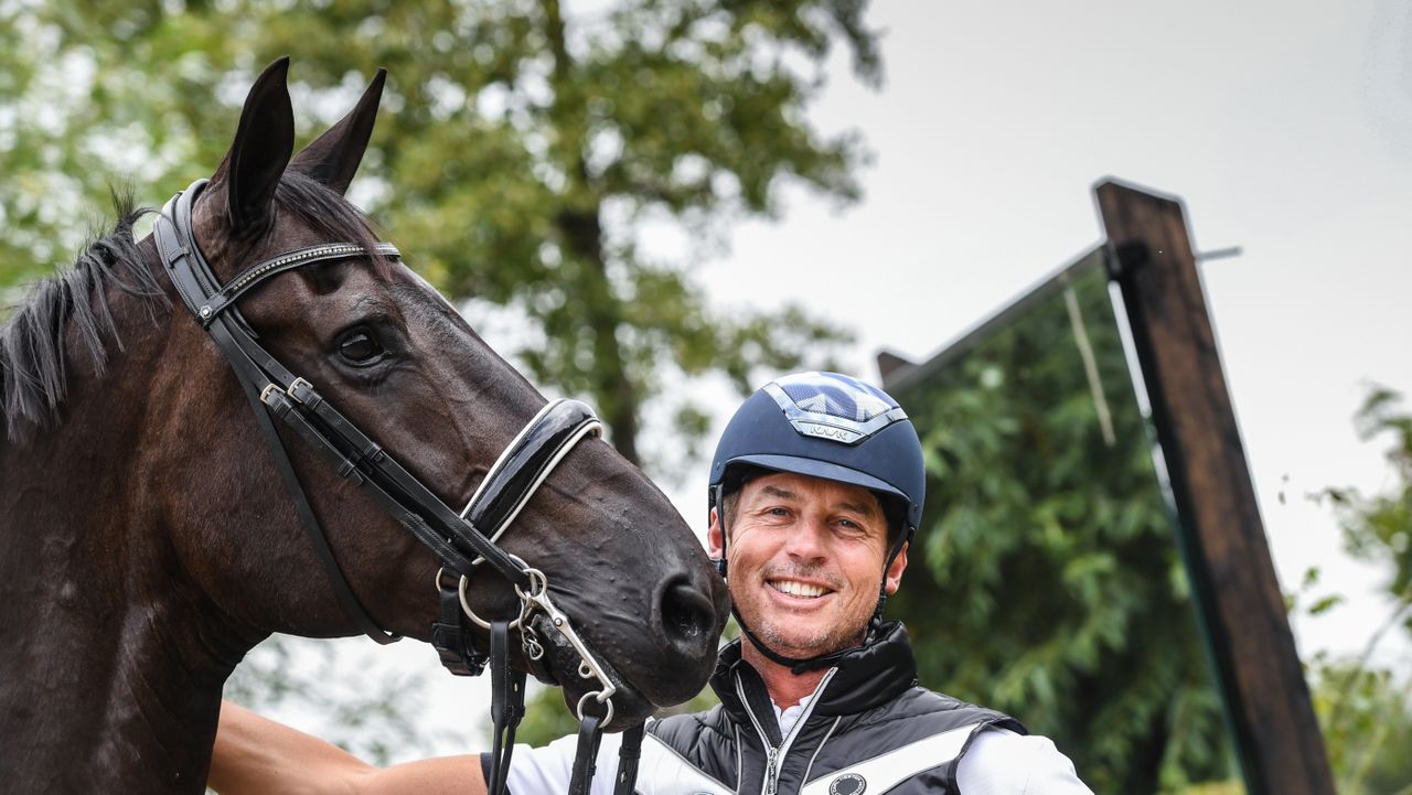 Carl Hester picture at home giving his horse, En Vogue, a pat