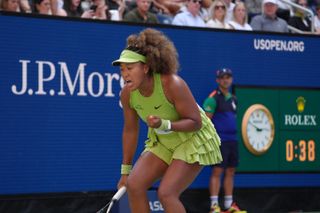 Naomi Osaka celebrates winning a point against Jelena Ostapenko of Latvia during their women's singles first-round match on day two of the US Open tennis tournament at the USTA Billie Jean King National Tennis Center in New York City on August 27, 2024