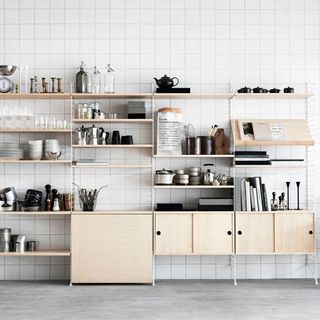 kitchen with white wall tiles and wooden shelf on wall