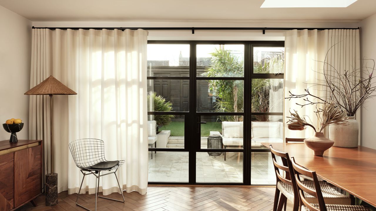 a dining room with automated curtains