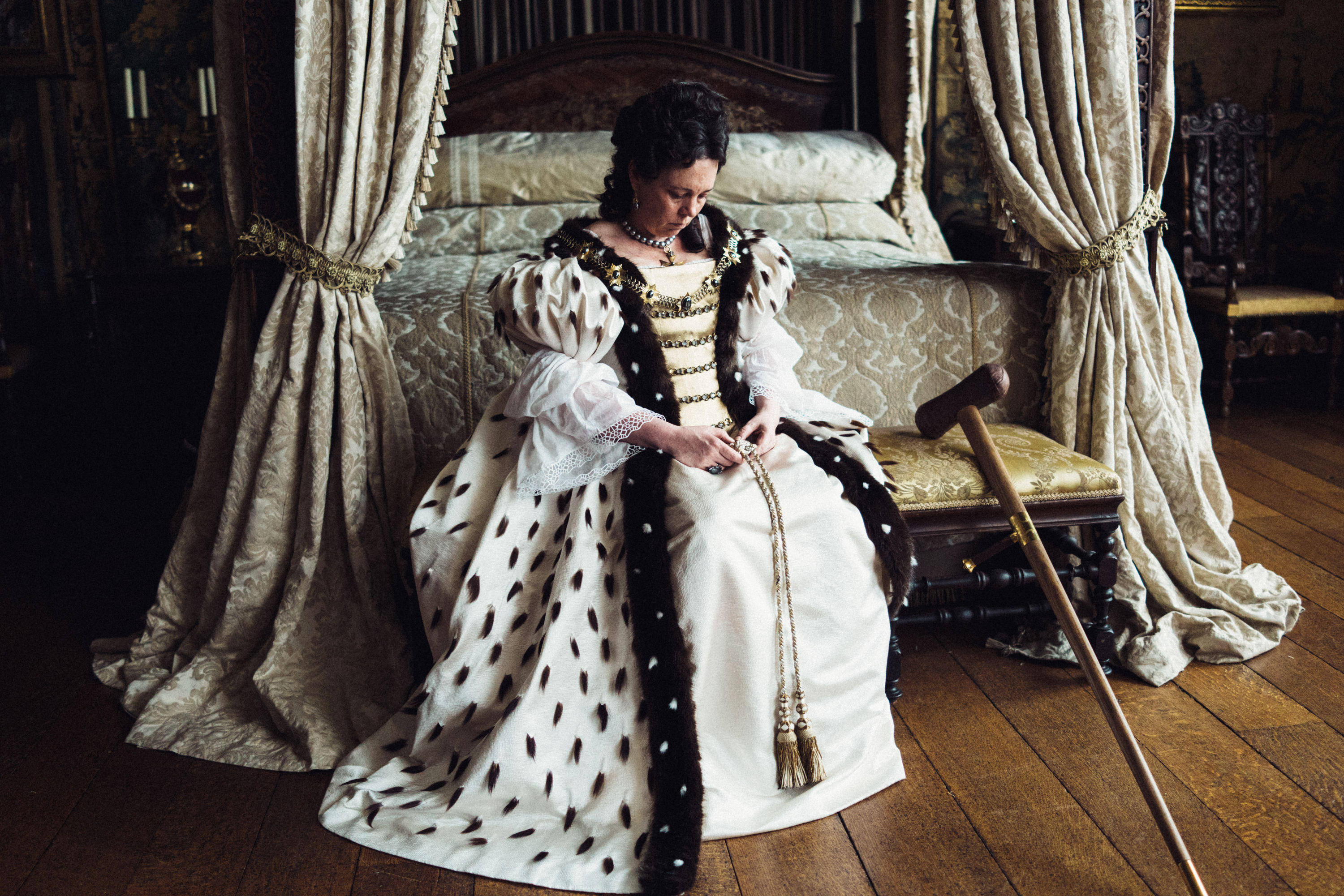 Olivia Colman in front of a bed in the film 'The Favourite'