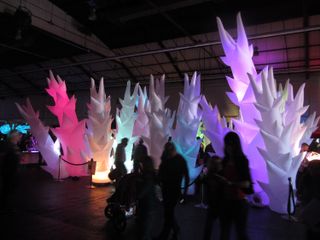 A light forest illuminates visitors at Maker Faire Bay Area in San Mateo, Calif., on May 18, 2013.
