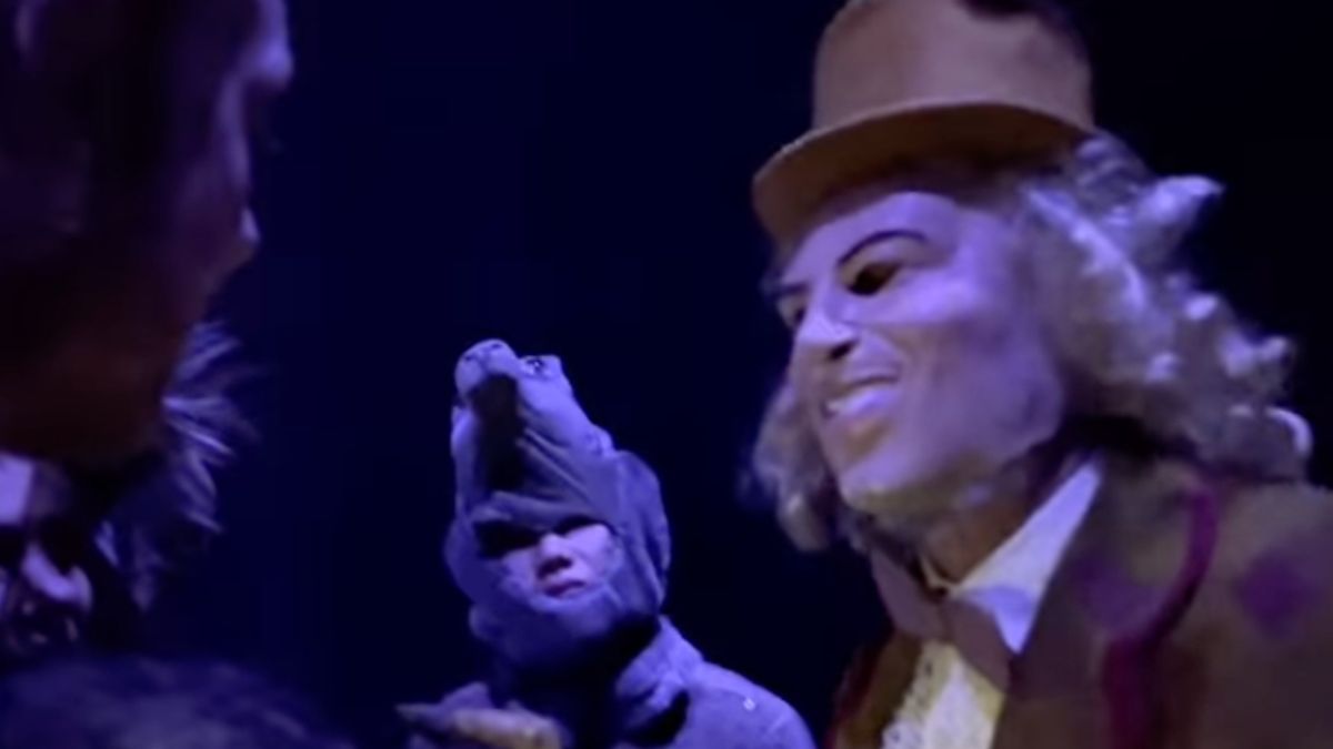 Tool bassist Justin Chancellor dressed in a Willy Wonka costume with mask