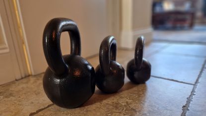A set of Amazon Basics kettlebells in the home of fitness writer, Lou Mudge