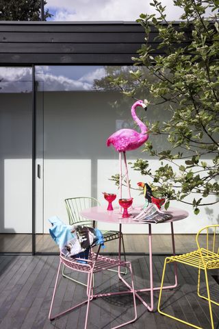 A small garden with a flamingo statue