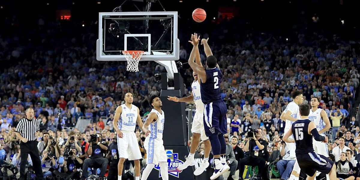 A college basketball player shots a 3-pointer at March Madness