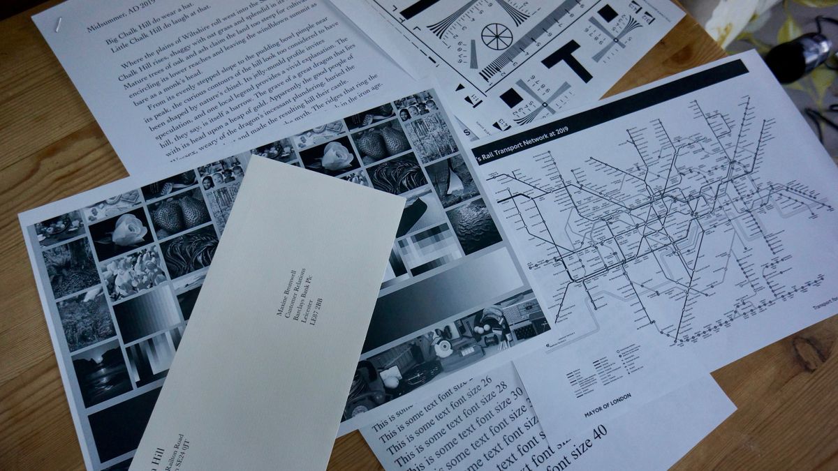 The Xerox VersaLink B600DN in a home office on a desk against a brick wall during our tests