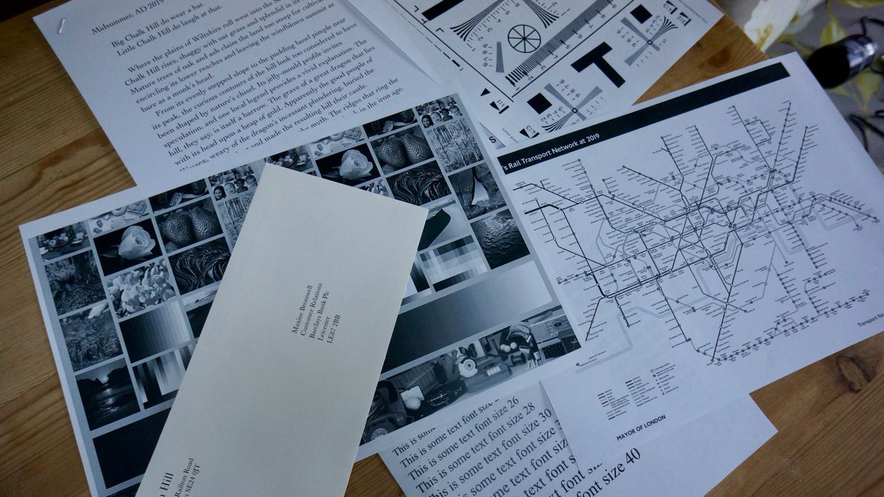 The Xerox VersaLink B600DN in a home office on a desk against a brick wall during our tests