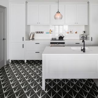 kitchen with white cabinet and black tiles