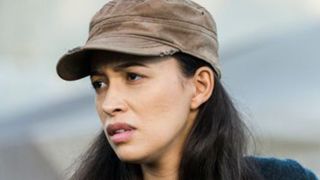 a close up of Christian Serratos wearing a tan hat