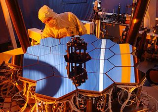 Through a process called "Wavefront Sensing and Control," or WFSC, software aboard the James Webb Space Telescope will compute the best position for each of 18 mirrors and one secondary mirror, and then adjust the positions. Engineers used a 1/6 scale model to test the WFSC software.