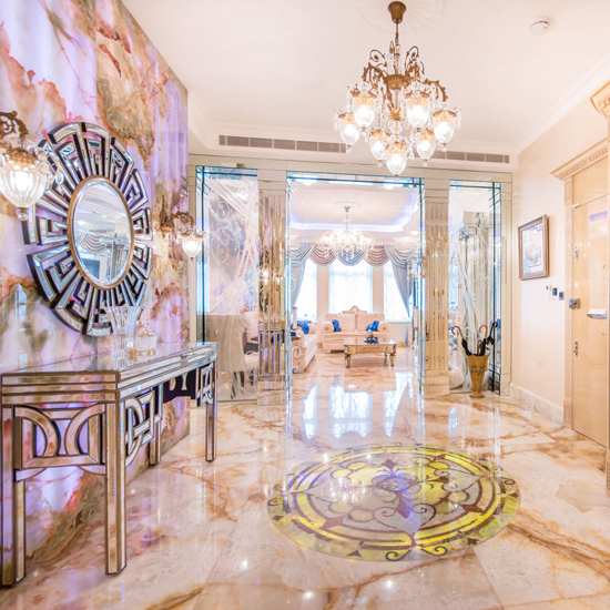 hallway with white wall and coral print wall with mirrored furniture.