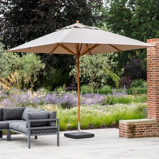 garden area with patio umbrella and grey sofa