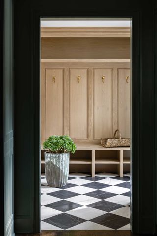 a mudroom entryway with checkered floor tiles