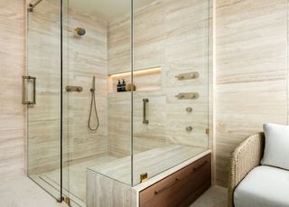 a shower with storage built into the seat