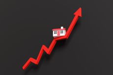 Toy house on a red up arrow on a black background.