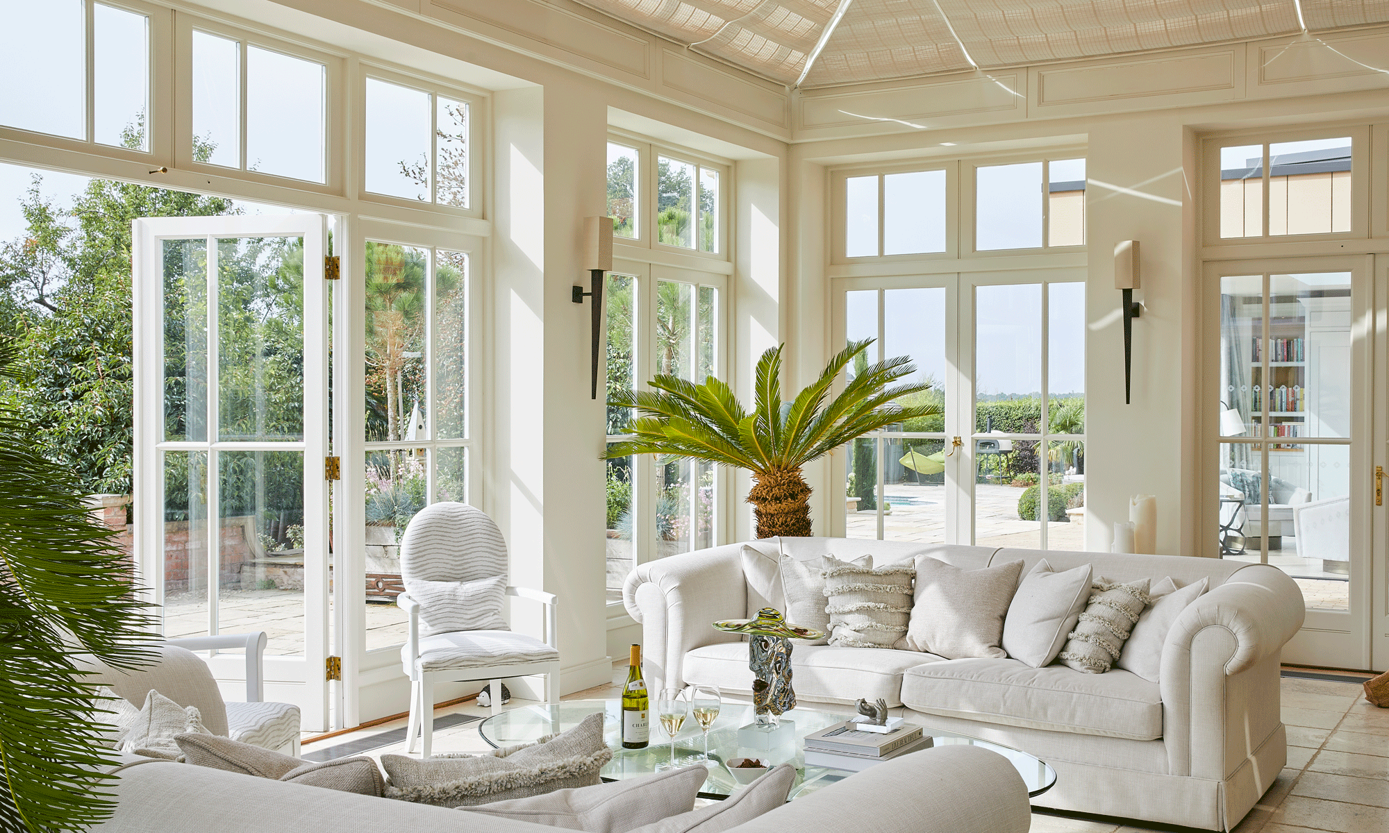 living room with tiled flooring and white sofaset with cushions