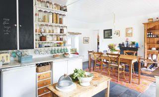 Open-plan kitchen-diner with upcycled furniture in a coastal home