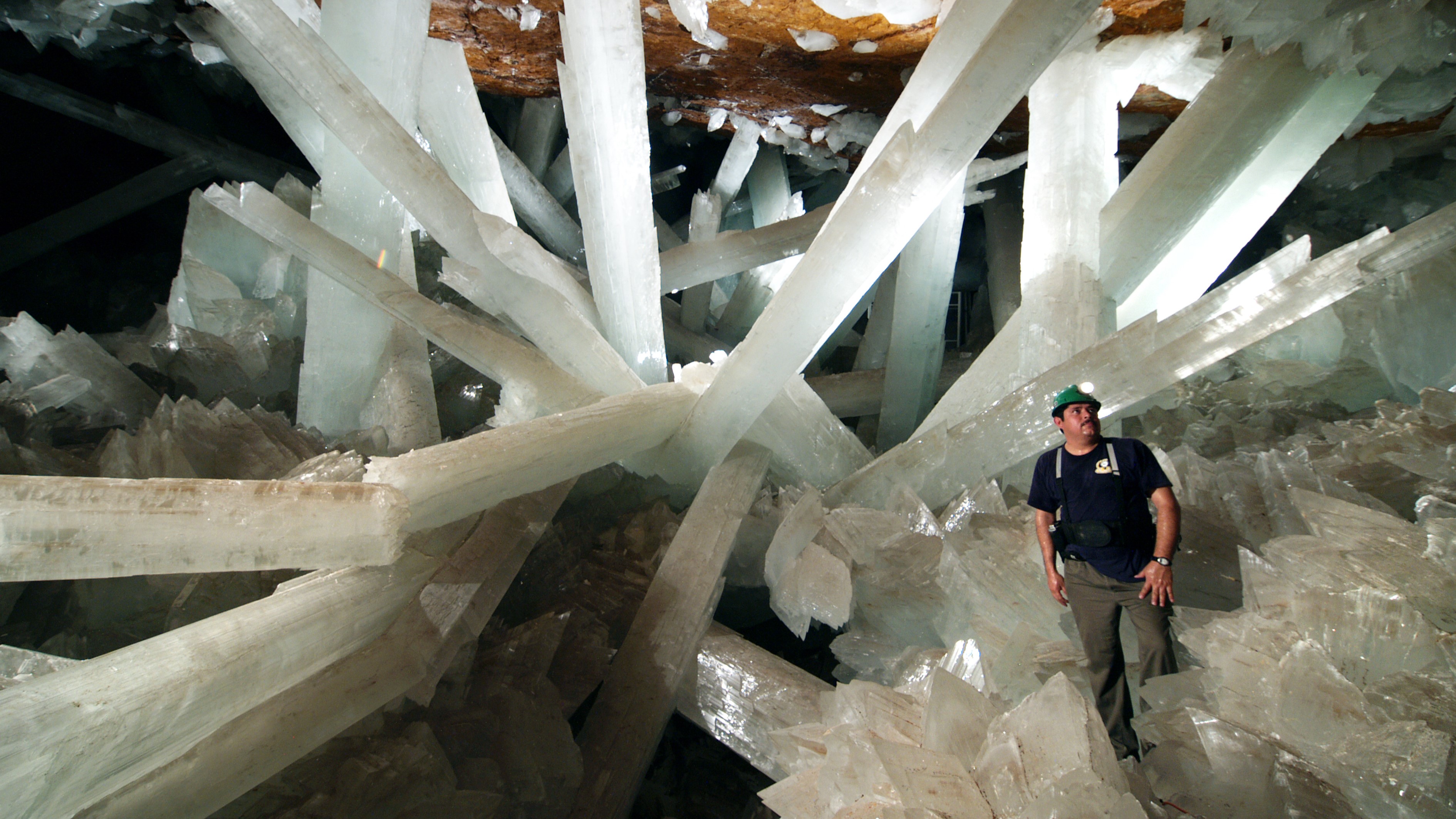 The interior of the Cave of Crystals with a geologist in the foreground.