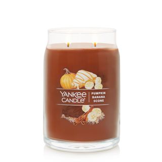 Signature Pumpkin Banana Scone Scented Jar Candle showing brown wax, two wicks and a fall inspired graphic on the front with pumpkins and cinnamon sticks 