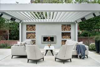 modern fireplace on patio with pale pergola overhead