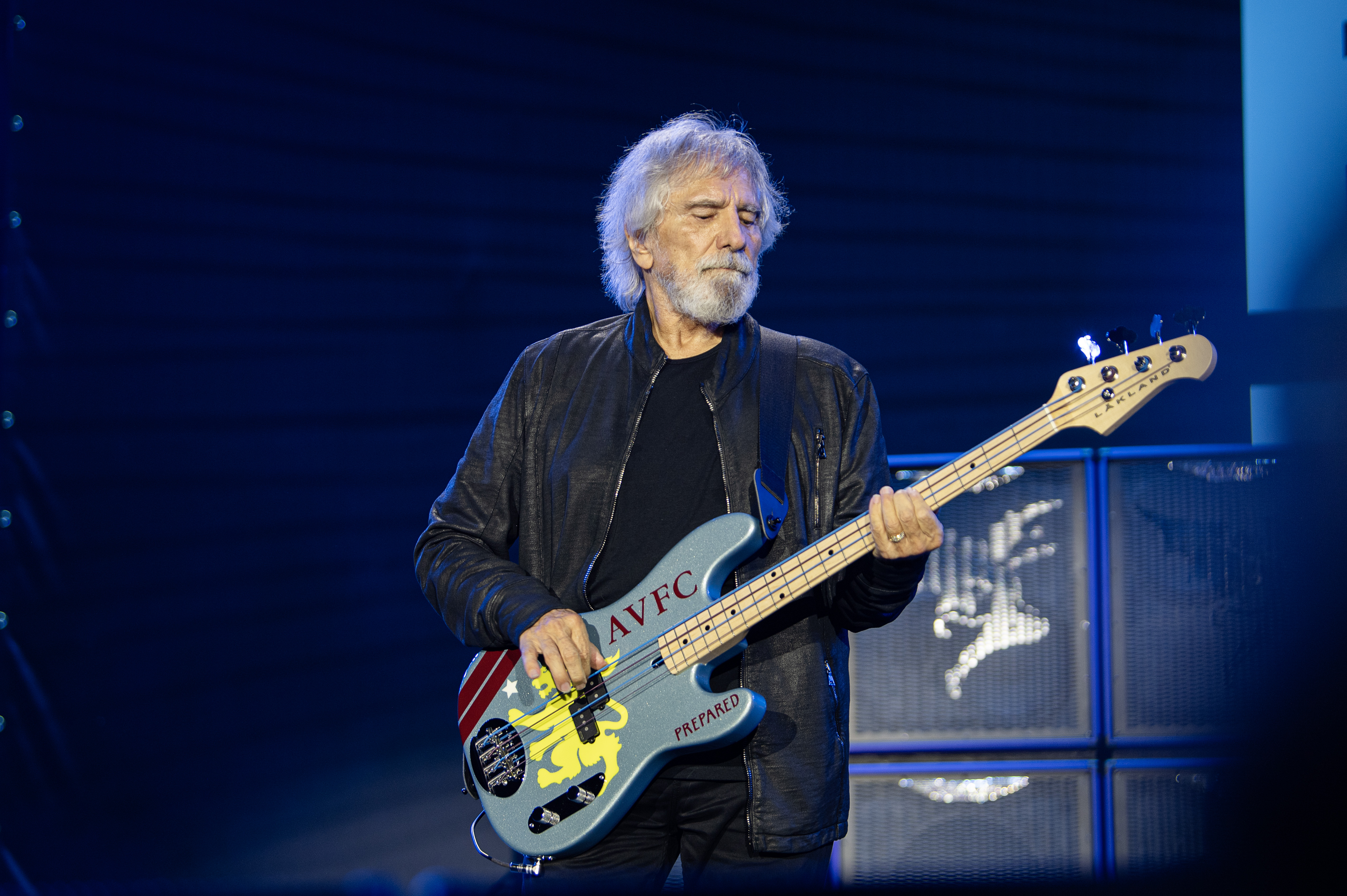 Geezer Butler playing bass on stage