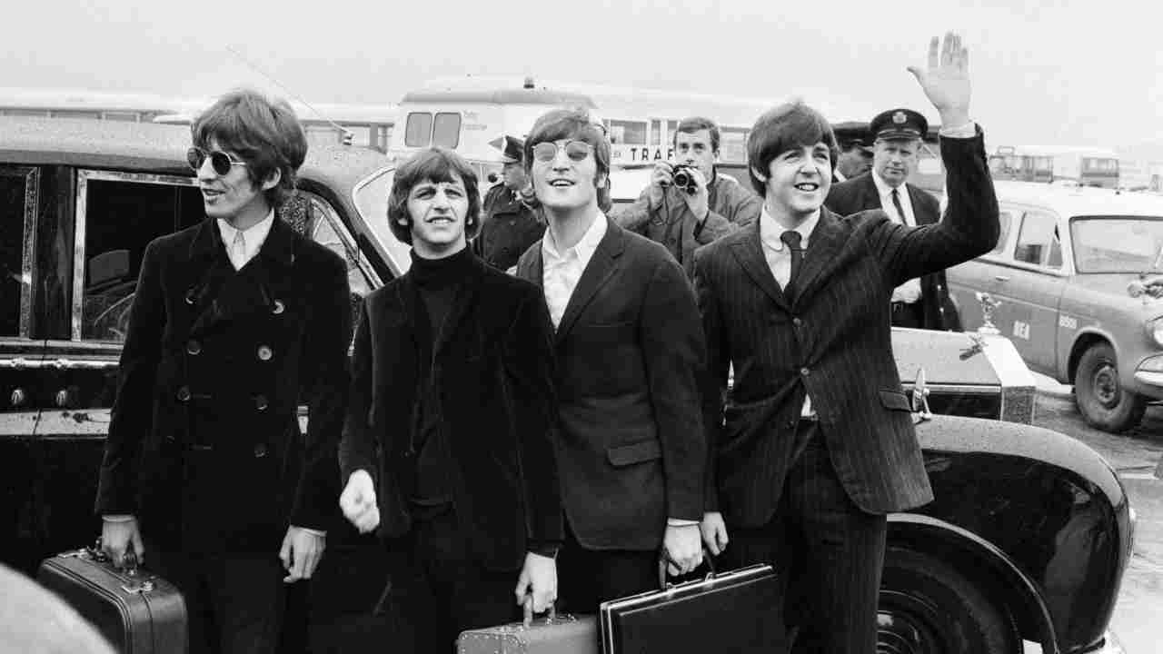 The Beatles posing for a photograph in 1966