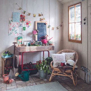 inside shed with potting table, chalkboard and chair