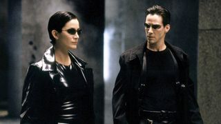 Trinity (Carrie Ann Moss) and Neo (Keanu Reeves) standing next to each other in "The Matrix"