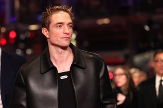 Robert Pattinson in a black leather jacket and black top at the premiere of Mickey 17 at the Berlinale International Film Festival in February 2025