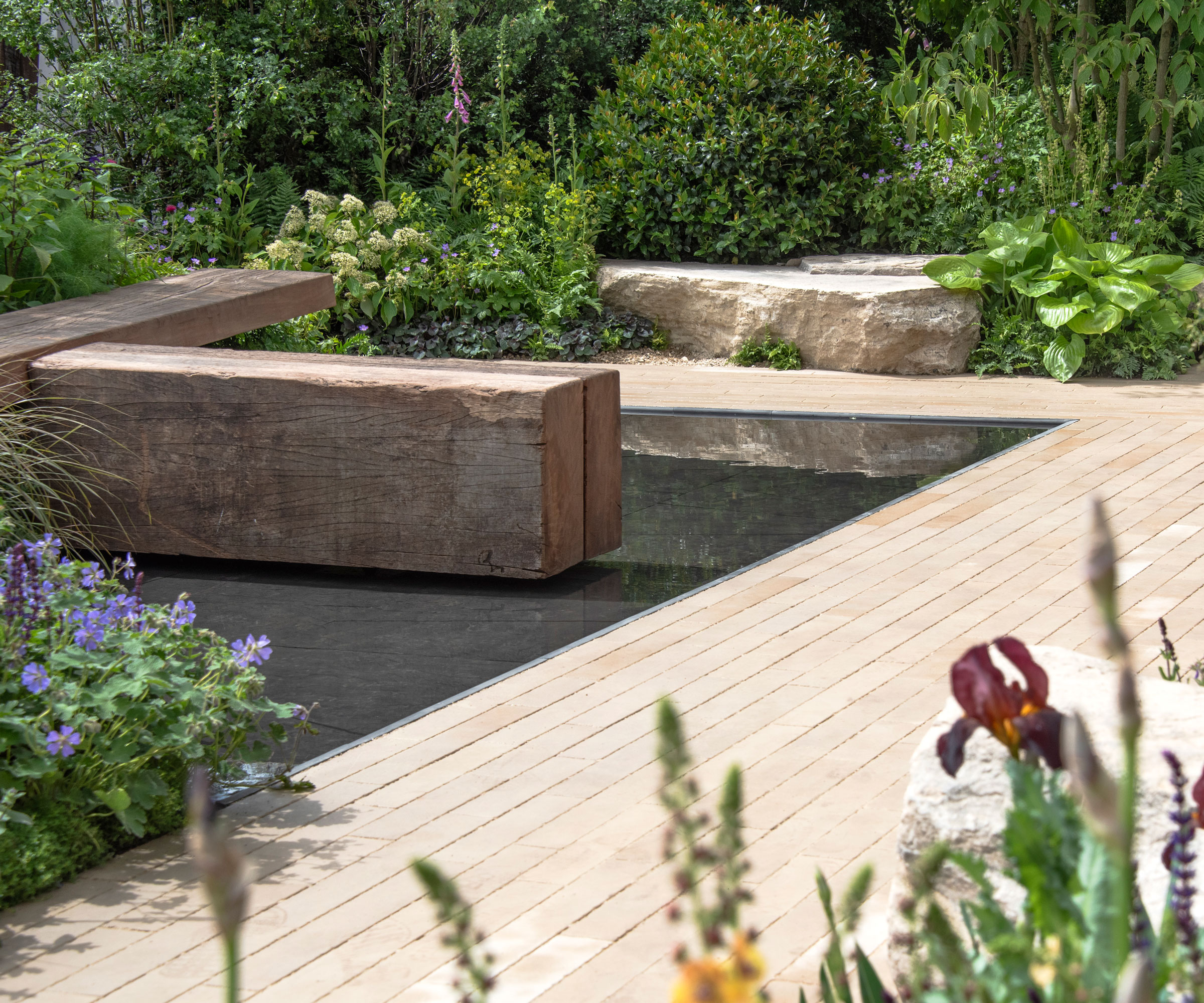 modern landscaping with decking boards and water feature, landscaping rocks and planting