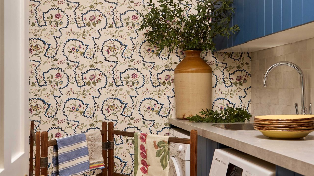 quirky wallpaper design in laundry room with wooden drying rack