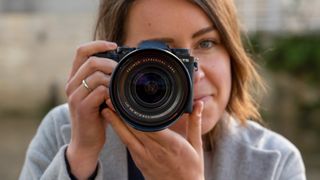 Woman holding Fujifilm X-T5 camera