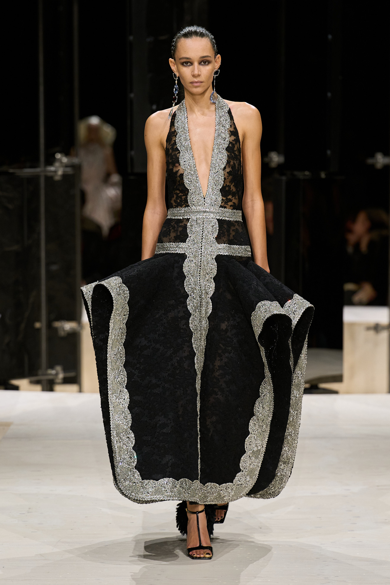 a model wears leopard a black lace dress.