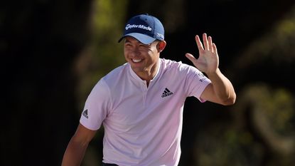 Collin Morikawa waves to the crowd at Augusta National