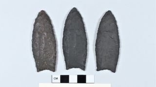 Three large, black arrowheads.