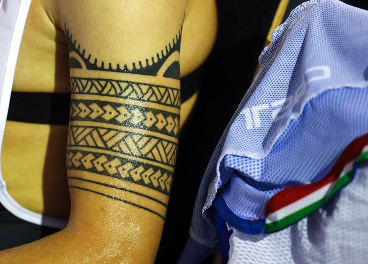 One of the Italians shows off his elaborate arm tattoo during team pursuit qualifying