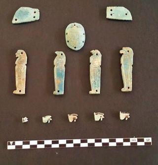 All of the tombs contain the remains of amulets made of faience. Some of the amulets are in the shape of Egyptian deities, such as Anubis, the jackal-headed god of the dead.
