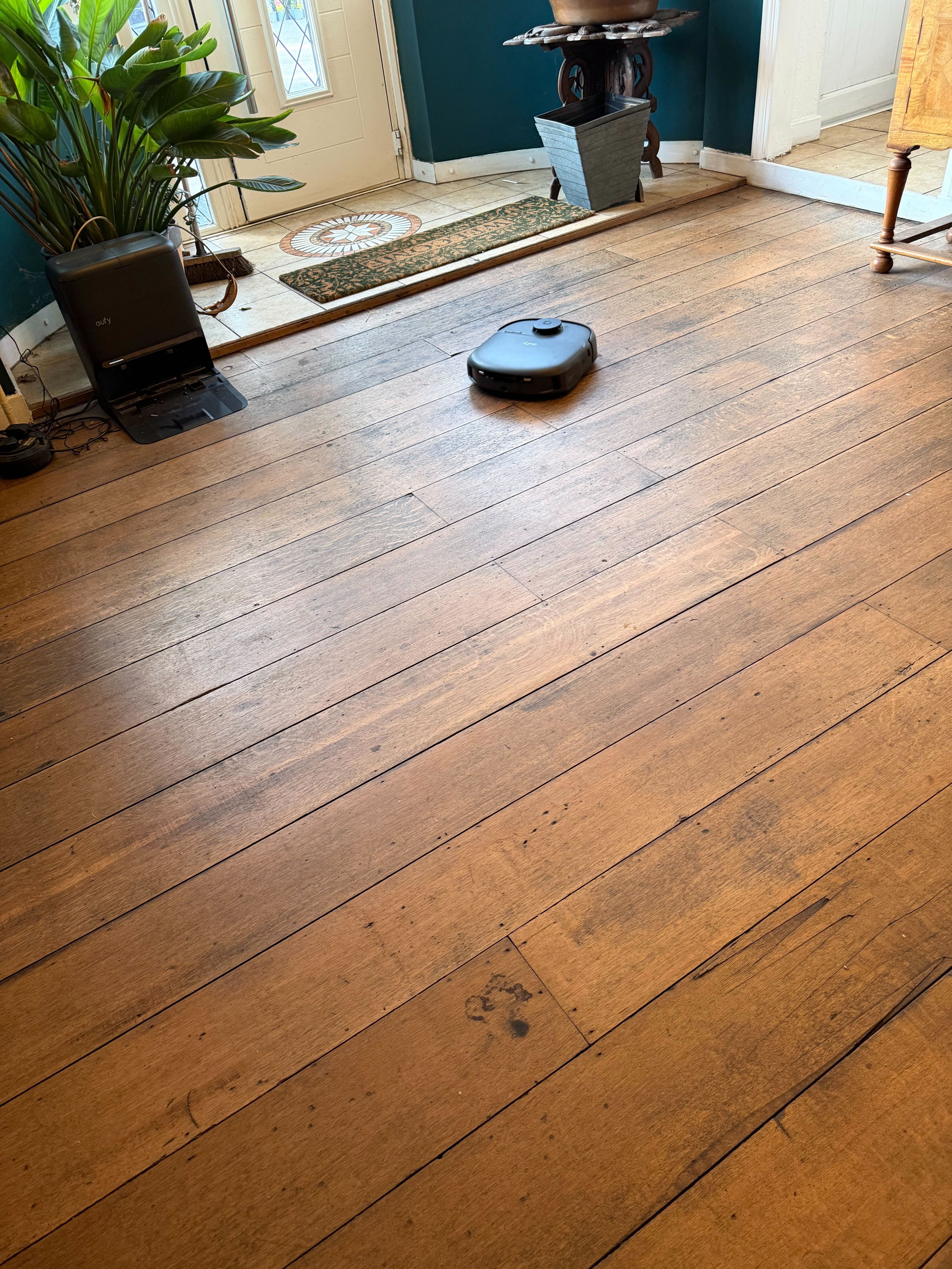 A eufy robot on a wooden floor