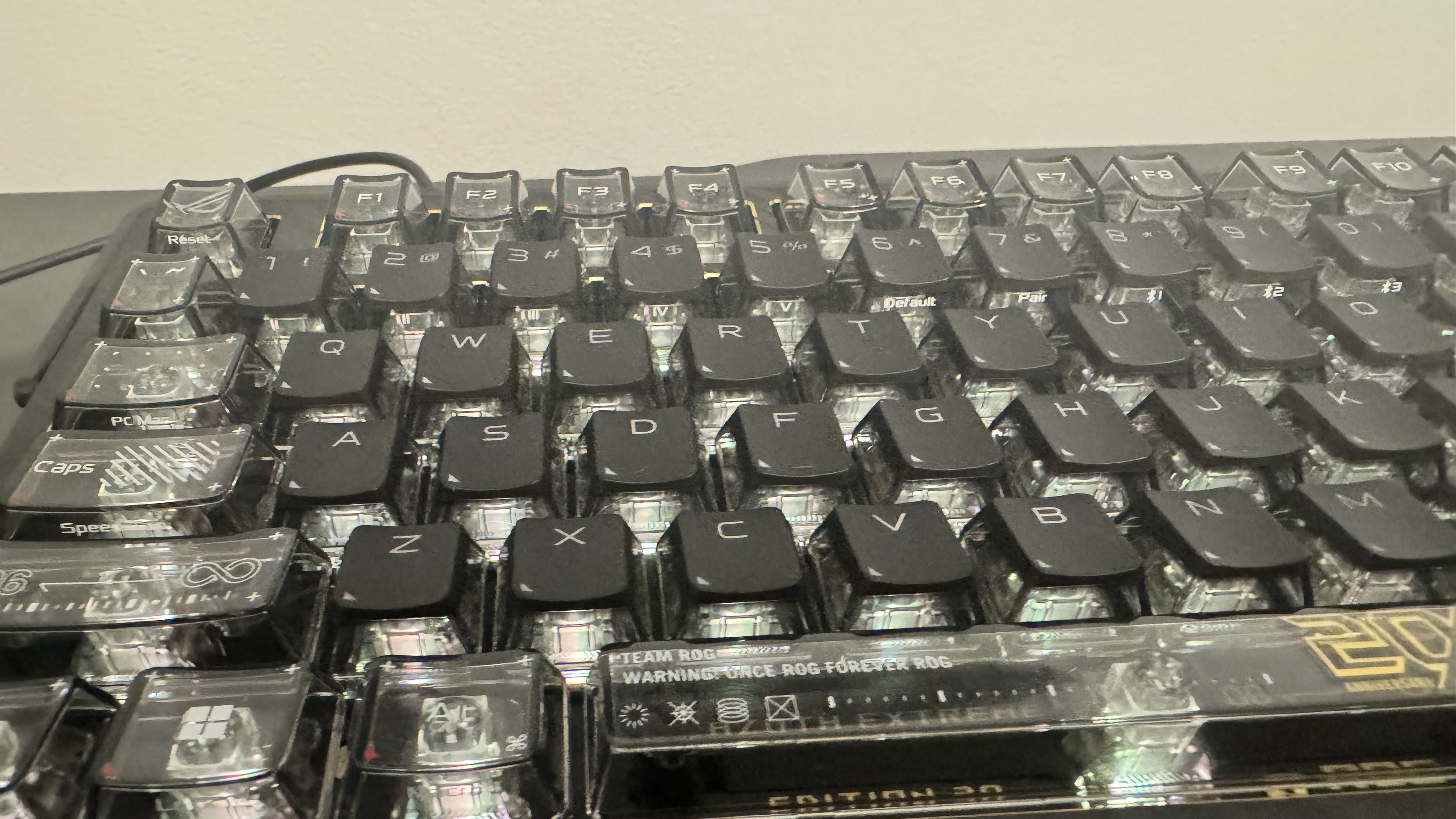 Asus ROG Azoth Extreme Edition 20 from the left hand side, on top of a black table