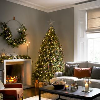 living room with christmas tree and fire place