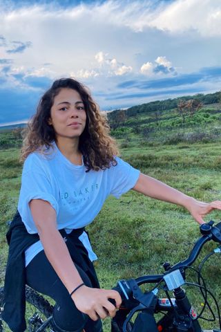 Beauty editor Morgan Fargo wears naturally curly hair while riding a bike