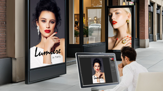 The new LG ProActive360 dignage solution on kiosks outside a storefront while a man superimposed on his laptop creates content. 