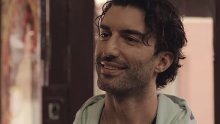Justin Baldoni smiling in a onesie in It Ends With Us 