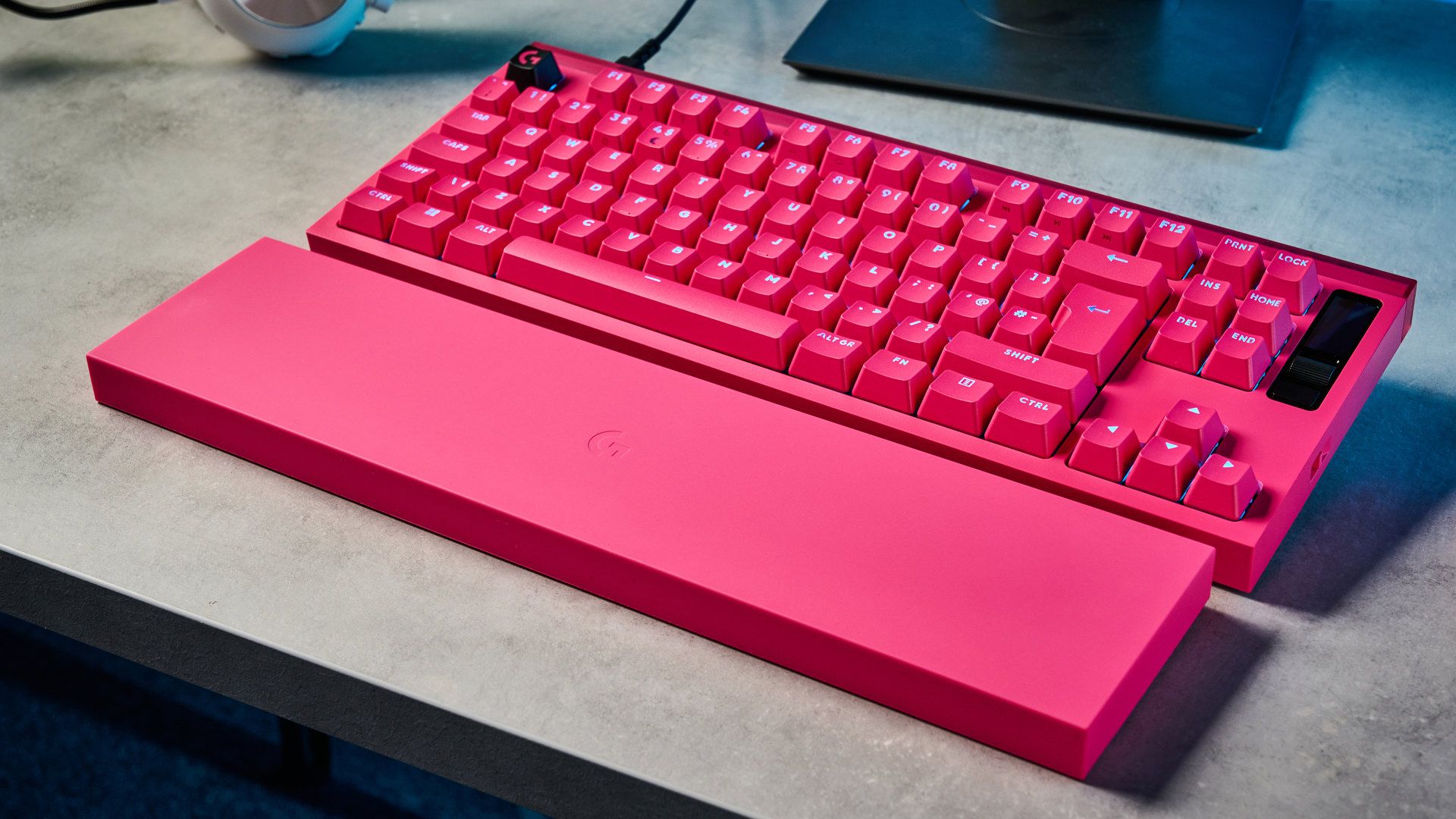 A photo of the Logitech G Pro X2 Rapid keyboard in hot pink on a stone surface