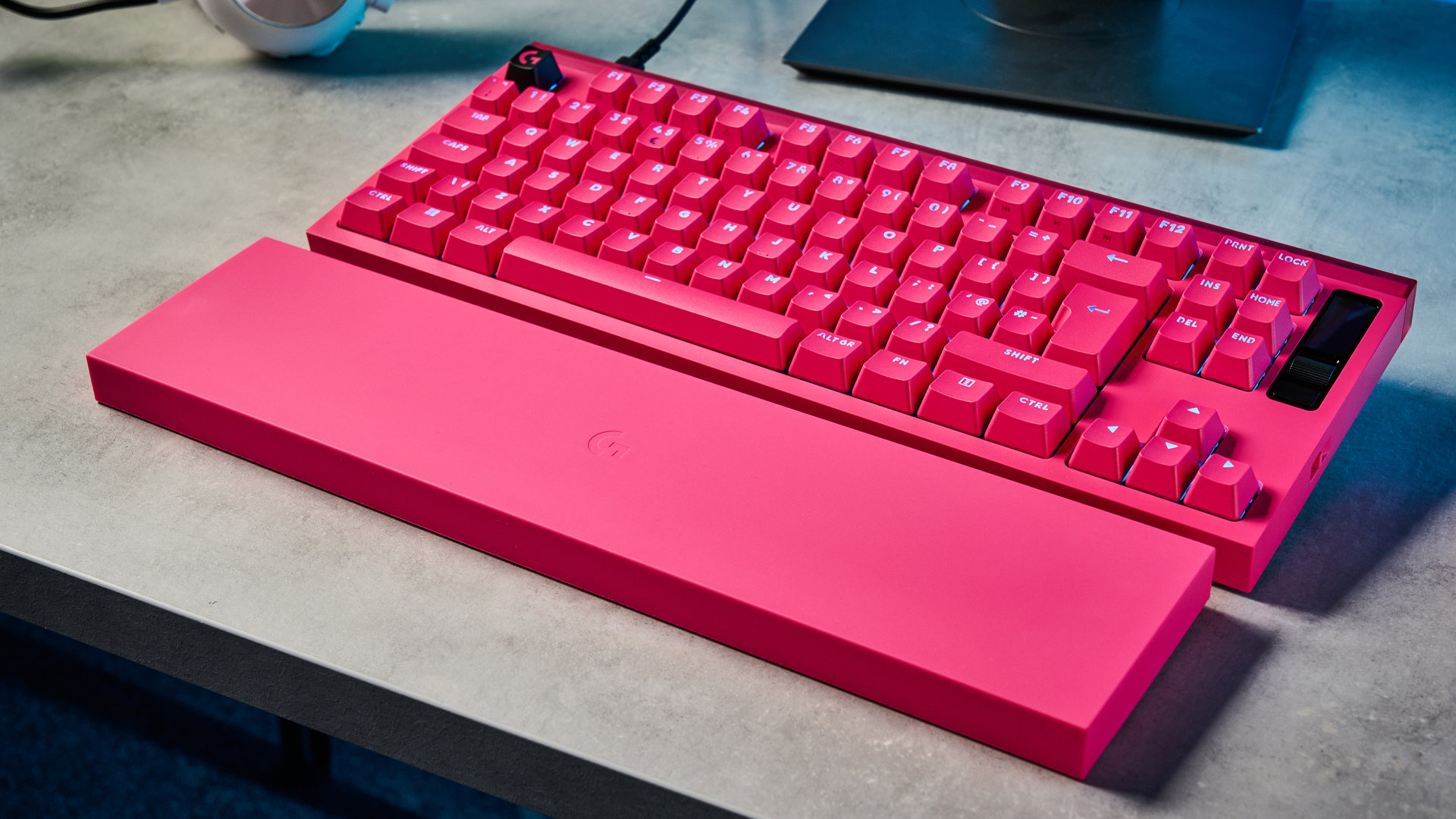 A photo of the Logitech G Pro X2 Rapid keyboard in hot pink on a stone surface