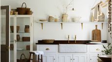 Utility room with ceiling-mounted drying rack and open shelving