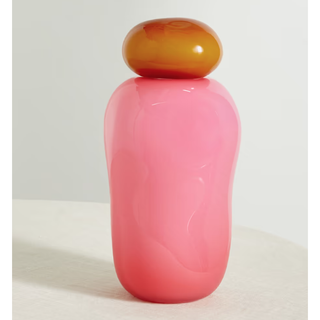 pink rounded vessel with an amber round lid