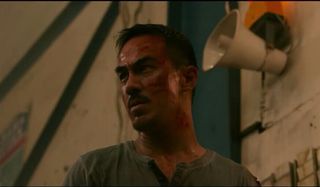 The Night Comes For Us Joe Taslim bloody and sweaty in a warehouse