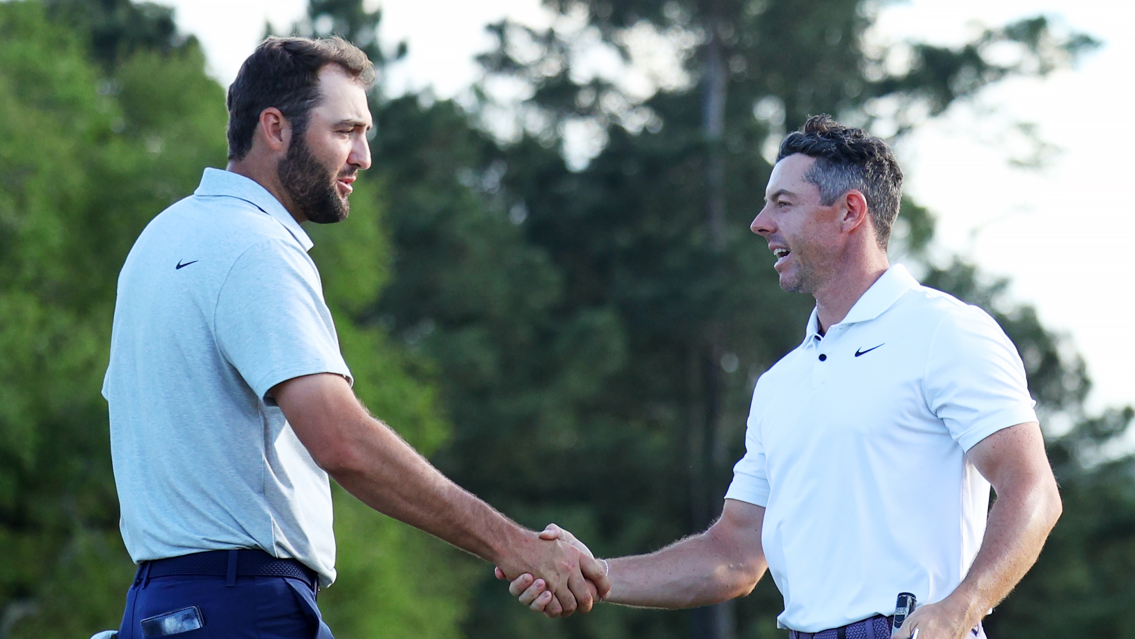 Scottie Scheffler of the United States and Rory McIlroy of Northern Ireland shaking hands. 